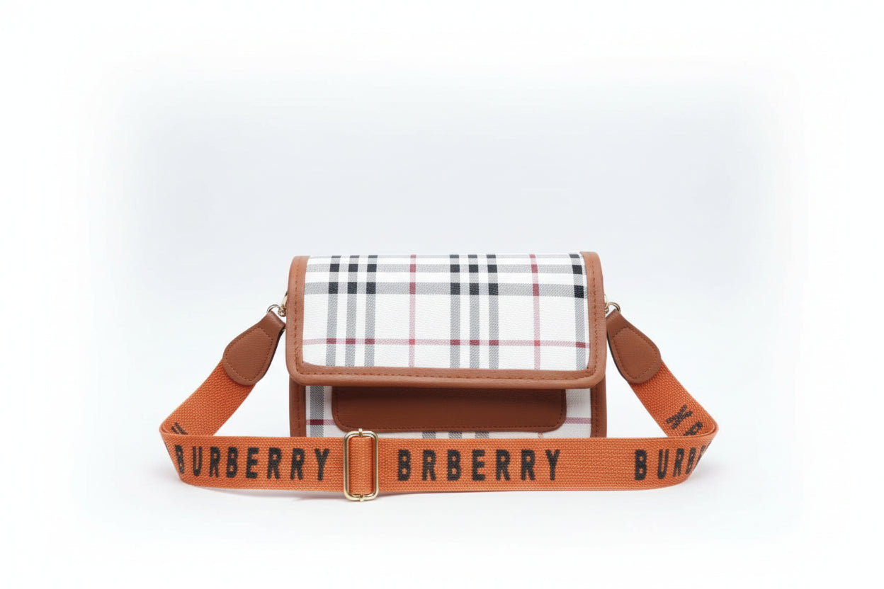 Burberry handbag with checkered pattern and orange strap on a striped background