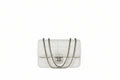 White quilted handbag with a chain strap on a white surface against a gray background