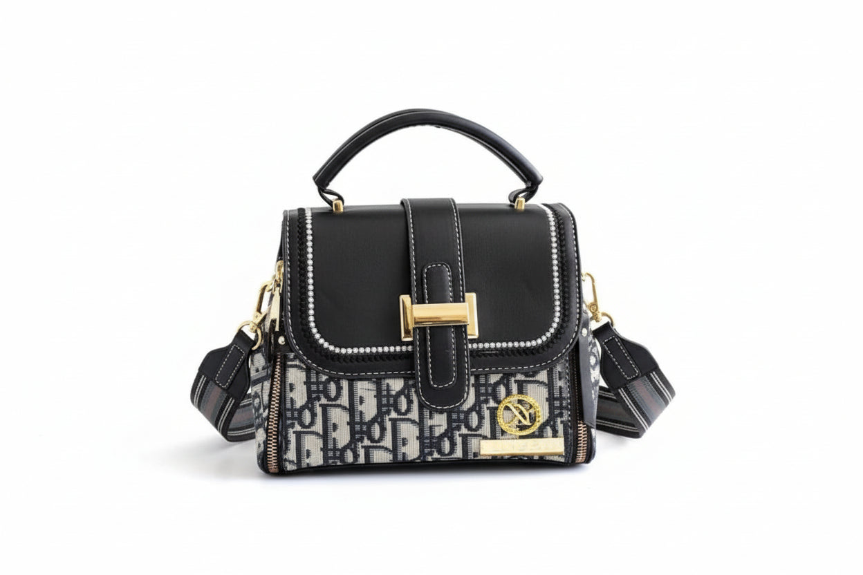 Black handbag with patterned flap held by a hand on a light background, with 'New Arrival' label.