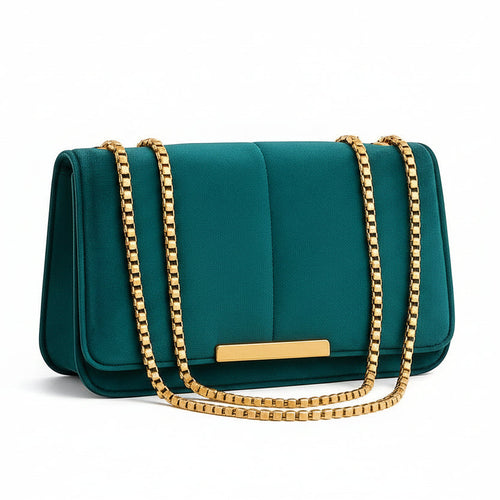 Teal handbag with gold chain on a beige background