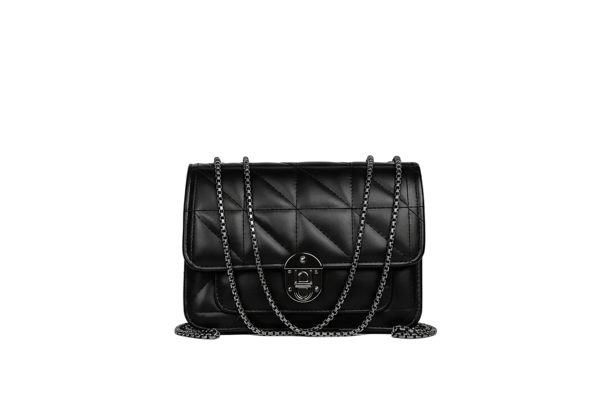 Black quilted handbag with chain strap on a white surface against a gray background