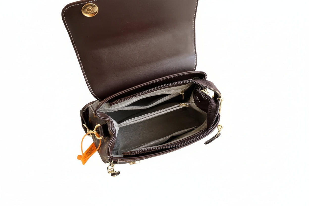 Open brown leather handbag on a white surface