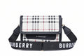 Burberry handbag with plaid pattern and matching strap on a striped background