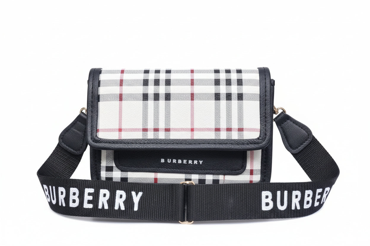 Burberry handbag with plaid pattern and matching strap on a striped background