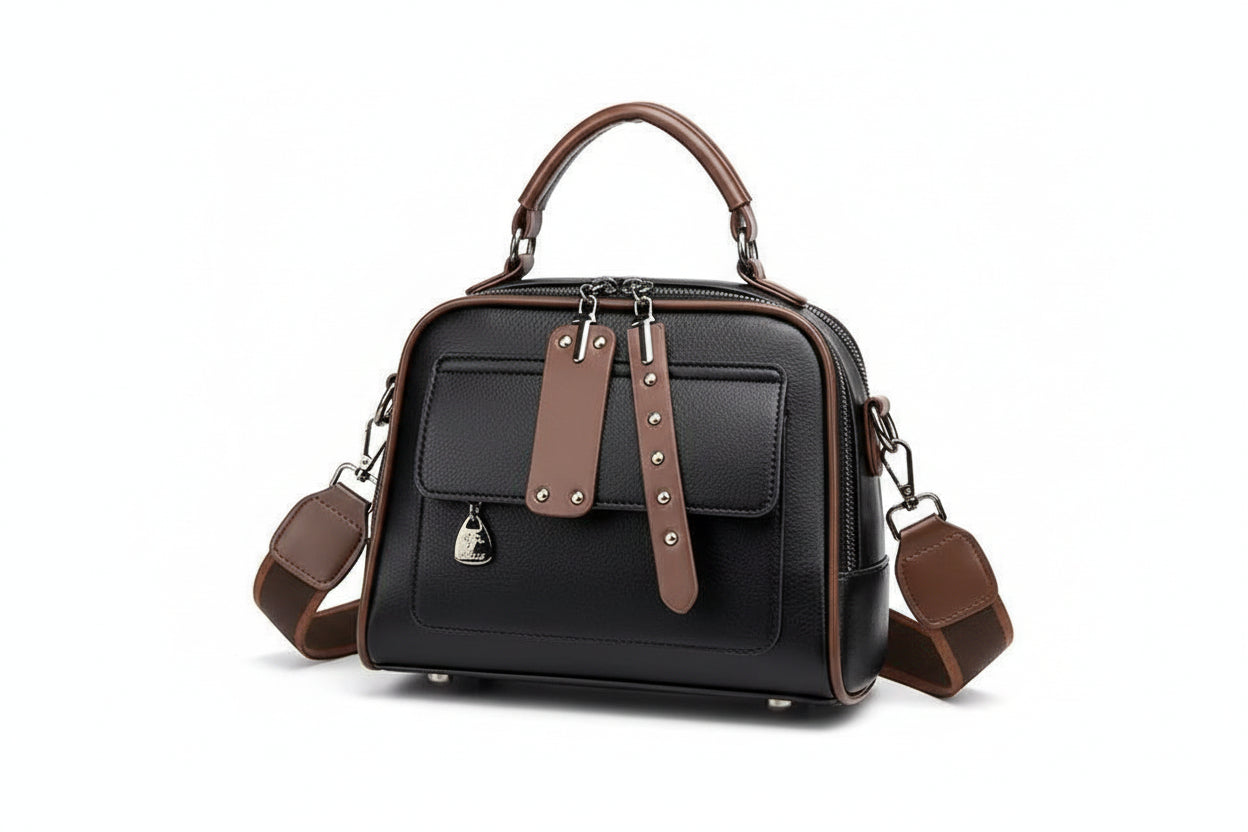 Black handbag with brown accents on a white background