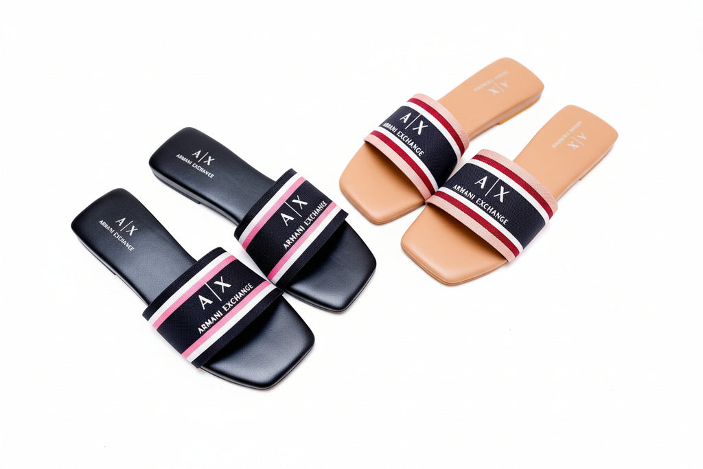 Two pairs of Armani Exchange slides on a white surface