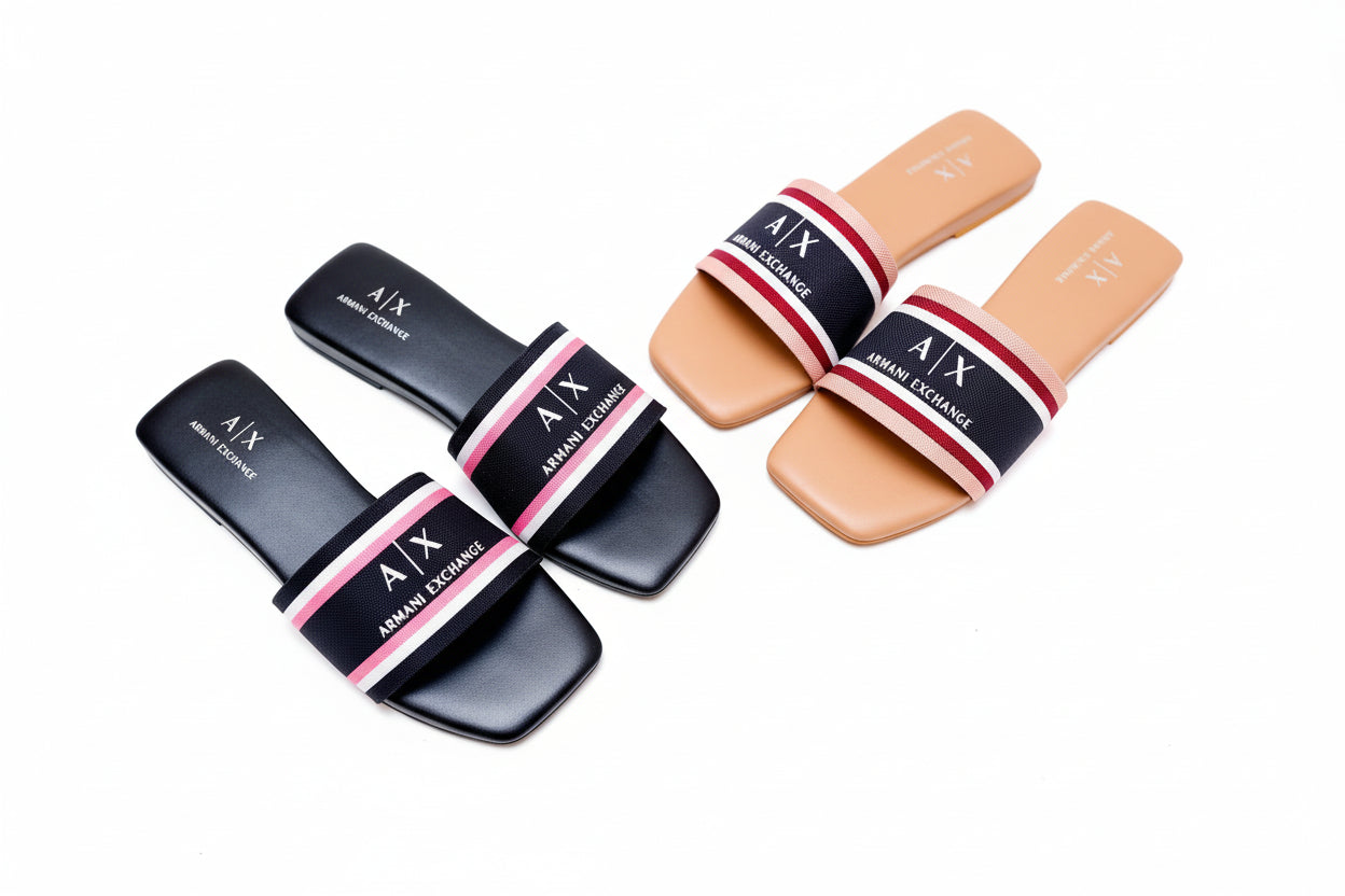 Two pairs of Armani Exchange slides on a white surface