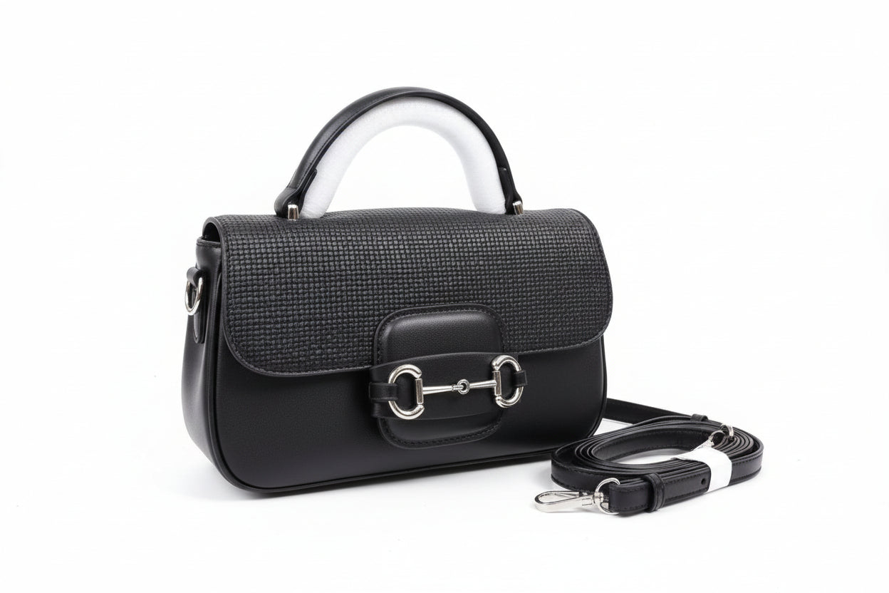 Black handbag with a strap on a brown box, with 'Burberry' branding.