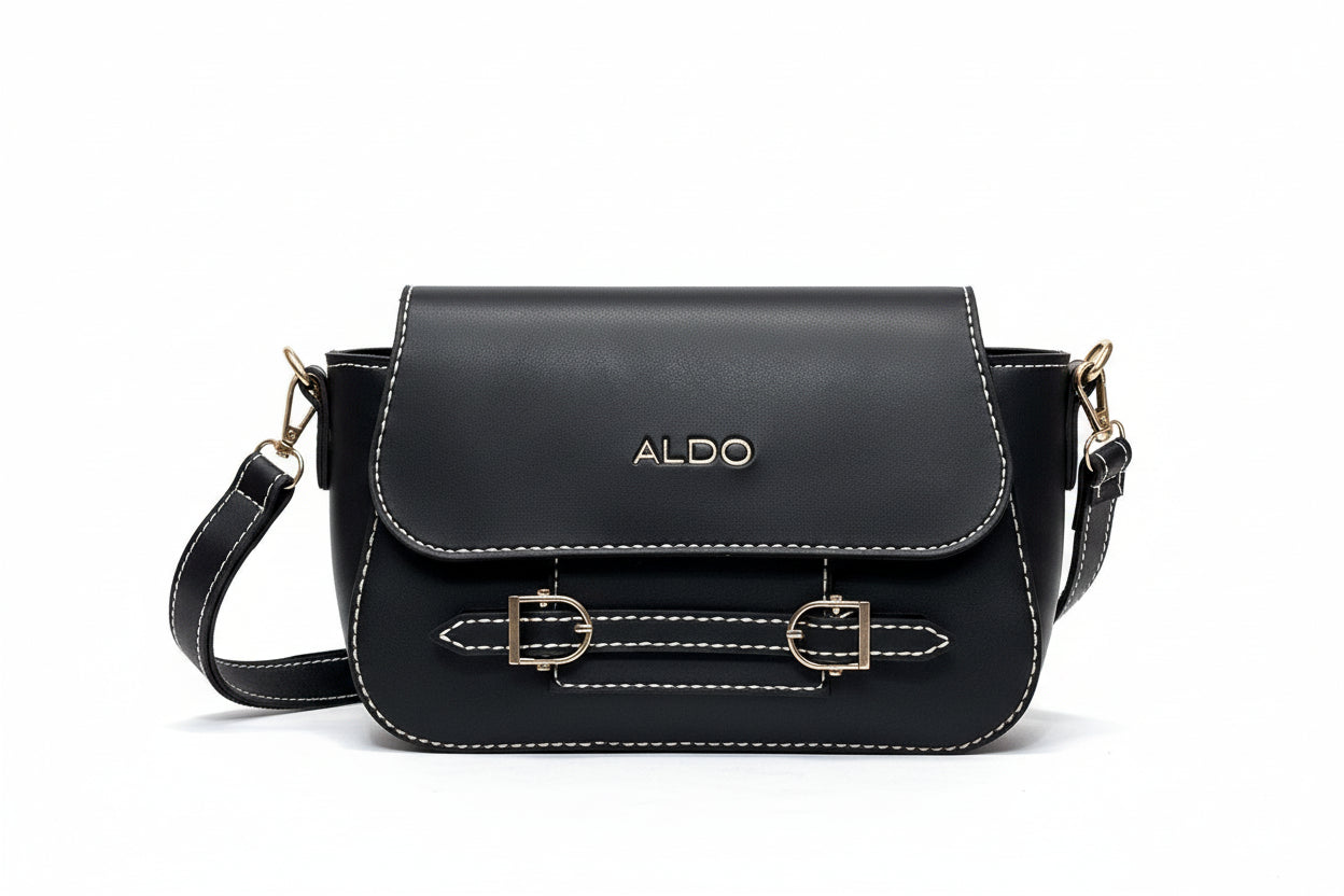 Black handbag with gold accents and 'ALDO' branding on a white fur surface.