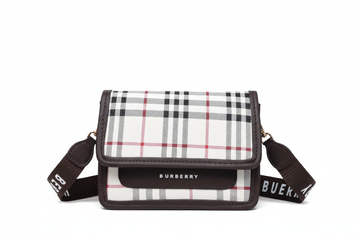 Burberry handbag with plaid pattern and branded strap on a light background
