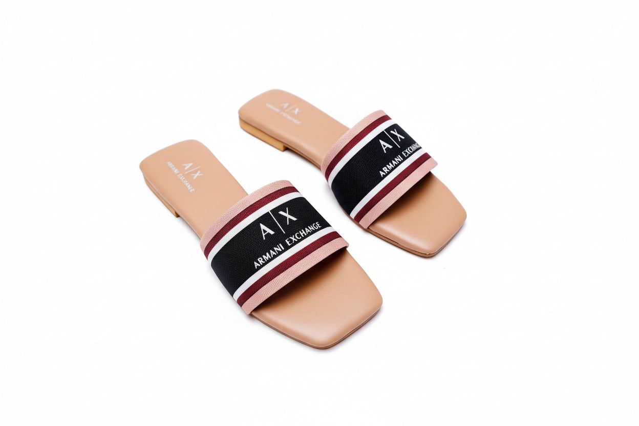 Pair of Armani Exchange slides on a white surface